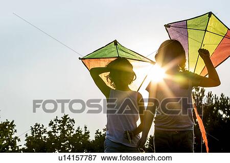 Stock Photo - Boys holding kite in park.. Fotosearch