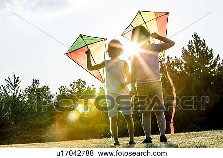 Boys holding kite in park. View Large Photo Image Stock Photo - Boys holding kite in park.. Fotosearch