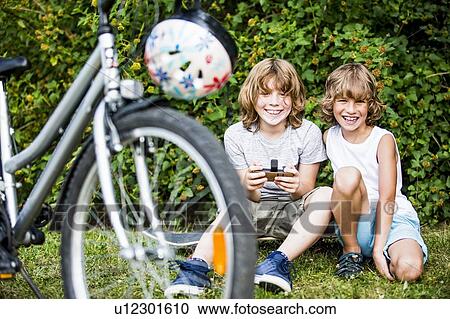 Boys playing games on mobile phone. View Large Photo Image Stock Image - Boys playing games on mobile phone.. Fotosearch