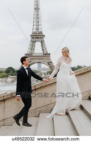 Bride and bridegroom, Eiffel Tower in background, Paris, France View Large Photo Image Stock Image - Bride and bridegroom, Eiffel Tower in background, Paris, France. Fotosearch