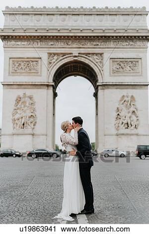 Bride and bridegroom kissing, Arc de Triomphe in background, Paris, France View Large Photo Image Stock Image - Bride and bridegroom kissing, Arc de Triomphe in background, Paris, France. Fotosearch