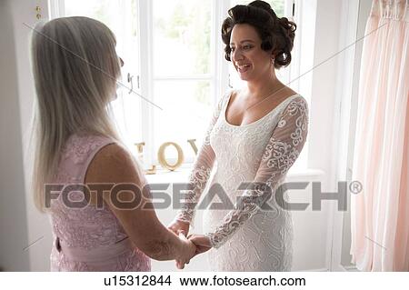 Bride and mother on morning of wedding day View Large Photo Image Picture - Bride and mother on morning of wedding day. Fotosearch
