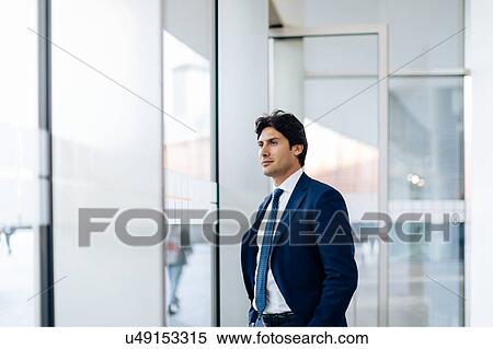 Stock Photography - Businessman in office building. Fotosearch