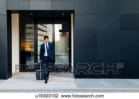 Businessman leaving on business trip View Large Photo Image Stock Image - Businessman leaving on business trip. Fotosearch