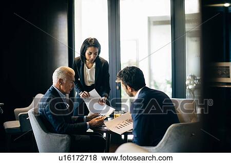 Businesswoman and men having meeting in hotel restaurant View Large Photo Image Stock Photo - Businesswoman and men having meeting in hotel restaurant. Fotosearch