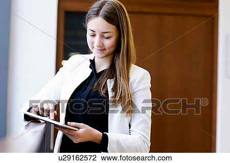 Stock Image - Businesswoman using digital tablet. Fotosearch