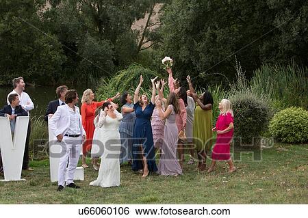 Stock Photograph - Catching the bride's bouquet. Fotosearch