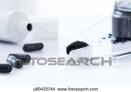Charcoal toothpaste on a toothbrush. View Large Photo Image Picture - Charcoal toothpaste on a toothbrush.. Fotosearch