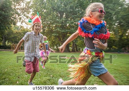 Stock Photograph - Children in costume running in park. Fotosearch