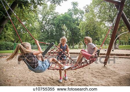 Stock Photography - Children playing on net swing. Fotosearch