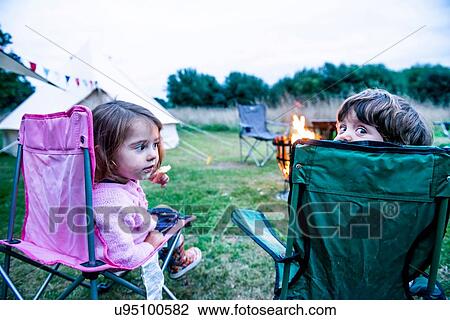 Children relaxing in front of bonfire View Large Photo Image Stock Image - Children relaxing in front of bonfire. Fotosearch
