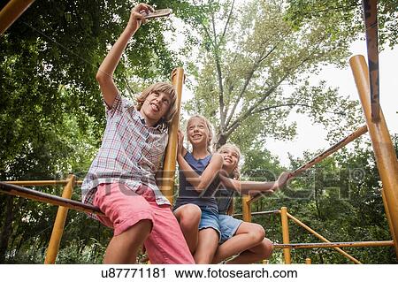 Children taking selfie on playground equipment View Large Photo Image Stock Image - Children taking selfie on playground equipment. Fotosearch