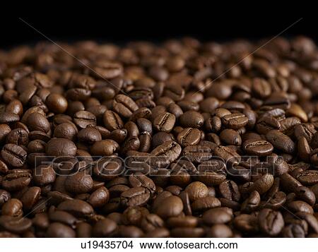 Picture - Coffee beans against a black background.. Fotosearch