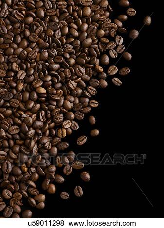 Stock Photo - Coffee beans against a black background.. Fotosearch