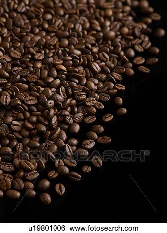 Stock Photograph - Coffee beans against a black background.. Fotosearch