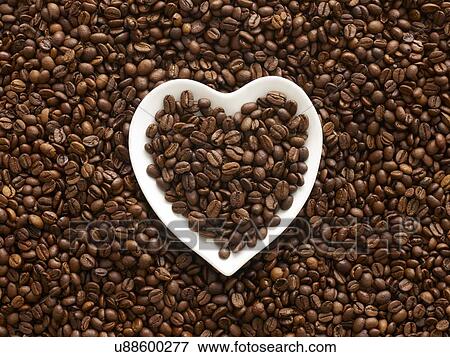 Stock Photo - Coffee beans in a heart shape bowl.. Fotosearch