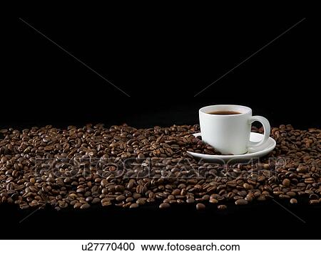 Stock Image - Coffee cup with coffee beans, studio shot.. Fotosearch