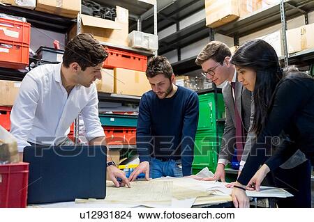 Picture - Colleagues in discussion in fencing prop workshop. Fotosearch