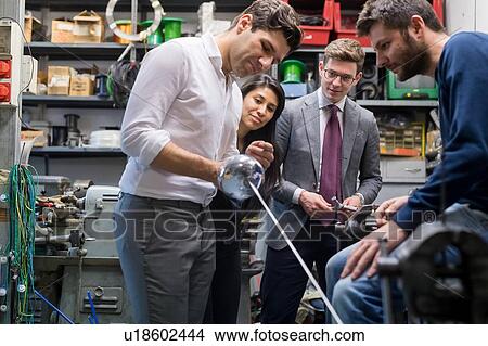Colleagues in discussion in fencing prop workshop View Large Photo Image Picture - Colleagues in discussion in fencing prop workshop. Fotosearch