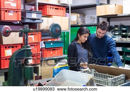 Colleagues working on delivery and packaging in warehouse View Large Photo Image Stock Image - Colleagues working on delivery and packaging in warehouse. Fotosearch