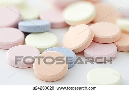 Stock Photo - Colourful antacid tablets against a white background.. Fotosearch