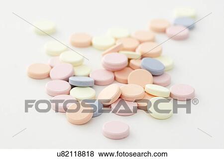 Stock Photo - Colourful antacid tablets against a white background.. Fotosearch