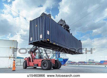 Stock Photograph - Container lift with shipping container in port. Fotosearch