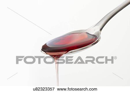 Stock Photo - Cough syrup dripping from a spoon.. Fotosearch