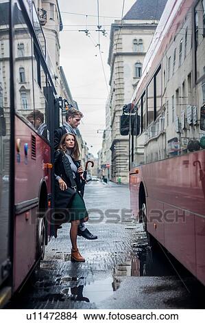 Picture - Couple commuting by bus, Budapest, Hungary. Fotosearch