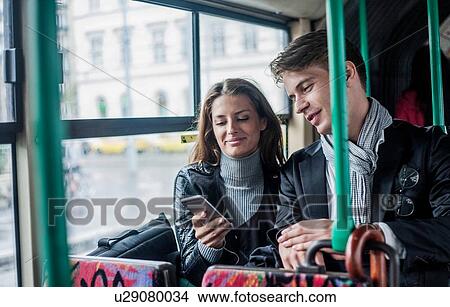 Picture - Couple commuting by bus, Budapest, Hungary. Fotosearch