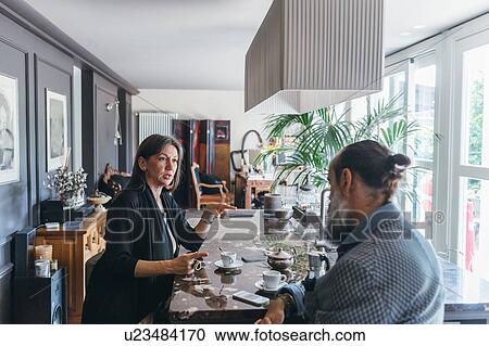 Couple in discussion over coffee in kitchen View Large Photo Image Stock Image - Couple in discussion over coffee in kitchen. Fotosearch