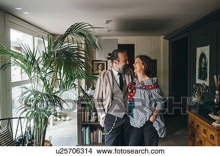Picture - Couple in living room at home. Fotosearch