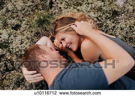 Couple lying on moss View Large Photo Image Stock Image - Couple lying on moss. Fotosearch