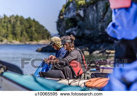 Stock Photography - Couple on kayaking trip, Johnstone Strait, Telegraph Cove, Canada. Fotosearch