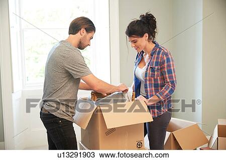 Couple packing mirror into cardboard box View Large Photo Image Stock Image - Couple packing mirror into cardboard box. Fotosearch