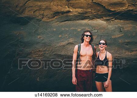 Stock Photo - Couple posing against rock face, Canoa, Manabi, Ecuador. Fotosearch
