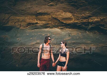 Couple posing against rock face, Canoa, Manabi, Ecuador View Large Photo Image Stock Photograph - Couple posing against rock face, Canoa, Manabi, Ecuador. Fotosearch