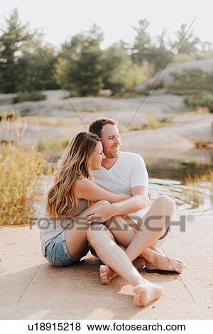 Couple sitting by water, Algonquin Park, Canada View Large Photo Image Stock Photo - Couple sitting by water, Algonquin Park, Canada. Fotosearch