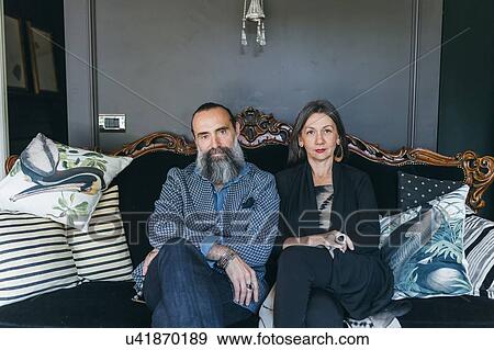 Couple sitting on antique sofa View Large Photo Image Stock Photo - Couple sitting on antique sofa. Fotosearch