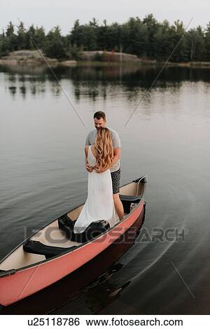 Couple standing on boat, Algonquin Park, Canada View Large Photo Image Stock Photograph - Couple standing on boat, Algonquin Park, Canada. Fotosearch