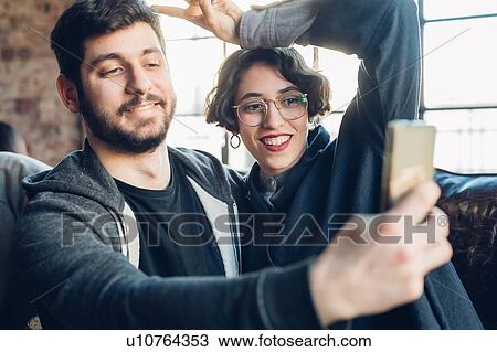 Stock Image - Couple taking selfie. Fotosearch