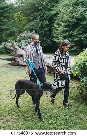 Couple walking dog in woods View Large Photo Image Stock Photography - Couple walking dog in woods. Fotosearch