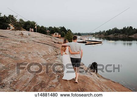 Stock Image - Couple walking with pet dog, Algonquin Park, Canada. Fotosearch