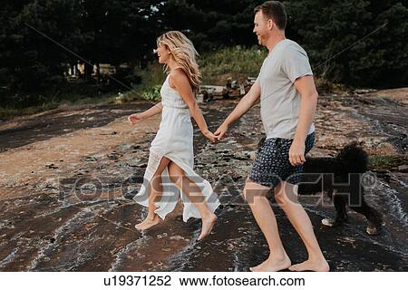 Couple walking with pet dog, Algonquin Park, Canada View Large Photo Image Stock Image - Couple walking with pet dog, Algonquin Park, Canada. Fotosearch