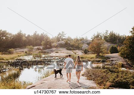 Couple walking with pet dog, Algonquin Park, Canada View Large Photo Image Stock Photo - Couple walking with pet dog, Algonquin Park, Canada. Fotosearch
