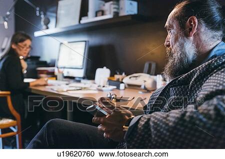 Couple working in home office View Large Photo Image Stock Image - Couple working in home office. Fotosearch