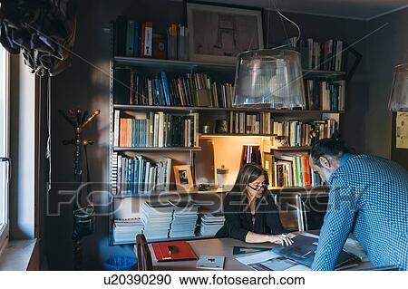 Stock Image - Couple working in home office. Fotosearch