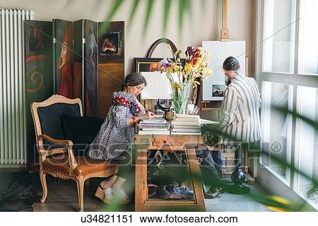 Stock Image - Couple working in their studio. Fotosearch