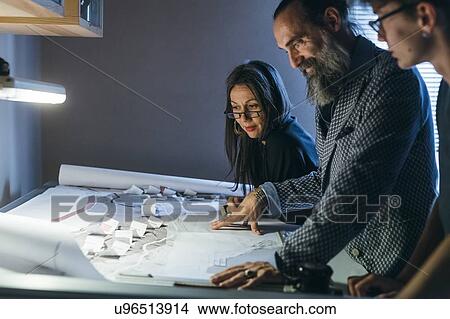 Picture - Couple working with son in home office. Fotosearch