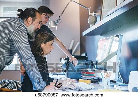 Stock Photo - Couple working with son in home office. Fotosearch